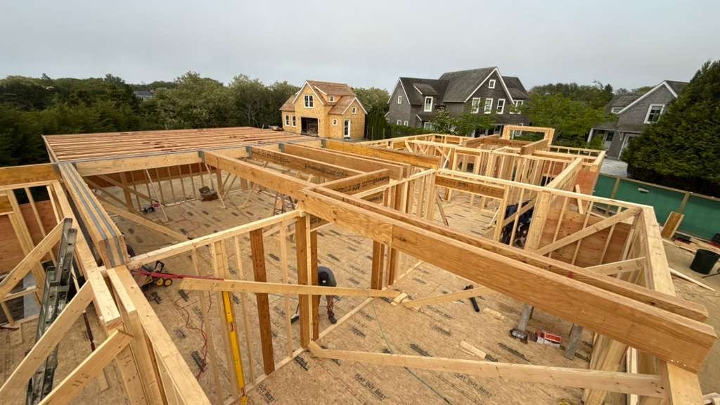 Precision wood framing of a new home addition, aerial view of the structure