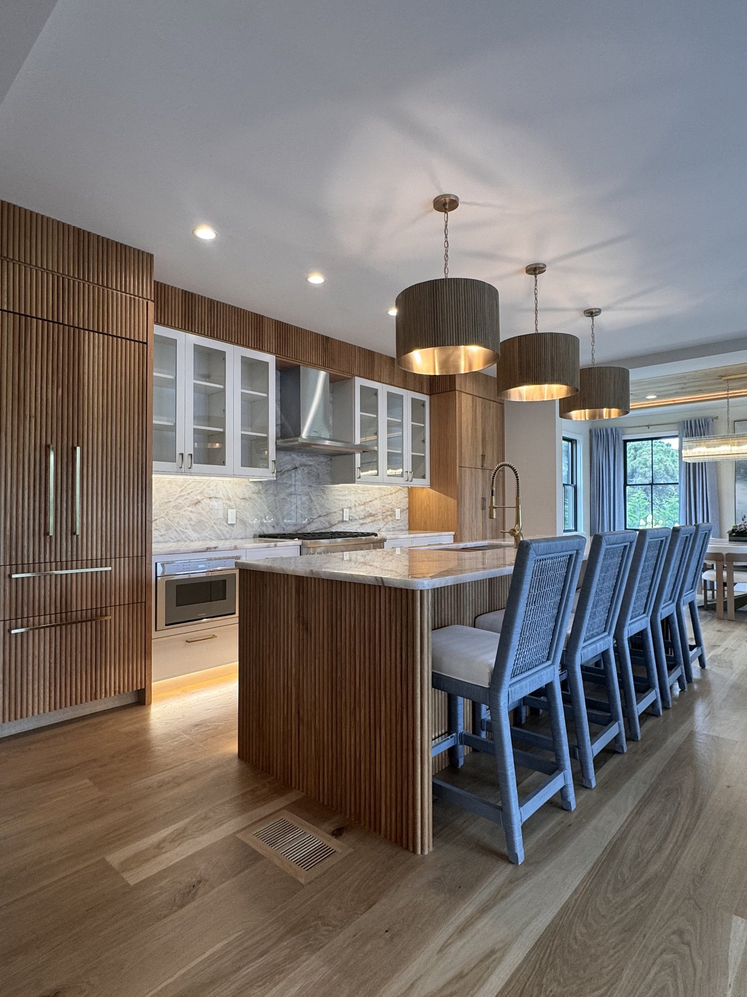 Custom kitchen remodel with white oak cabinetry and a marble island