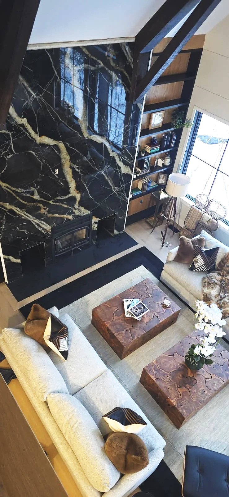 Double-height marble fireplace and feature wall with precise tile layout